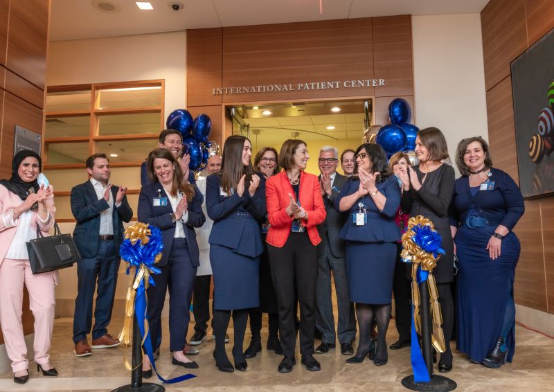 Staff from the International Patient Center (IPC) at Dana-Farber share a moment of joy after Laurie H. Glimcher ceremoniously cut a blue ribbon to mark its official opening on Jan. 16 - Dana-Farber Cancer Institute